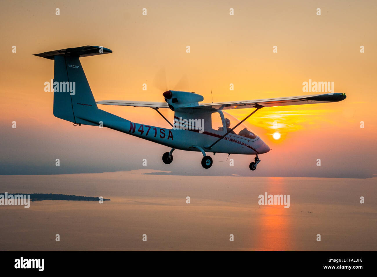Plane flying at sunset in Maryland Stock Photo