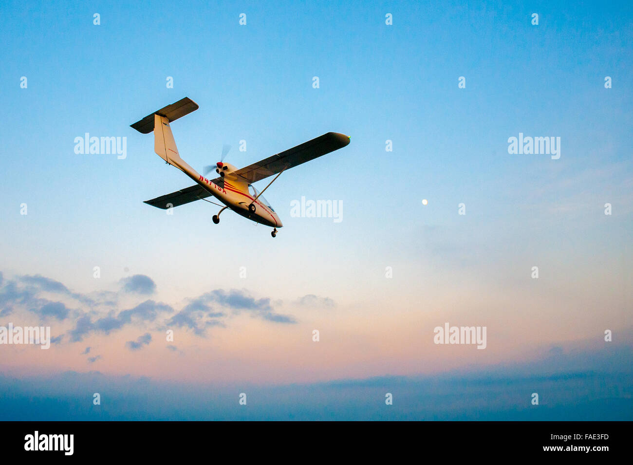 Small plane taking a flight at dusk Stock Photo