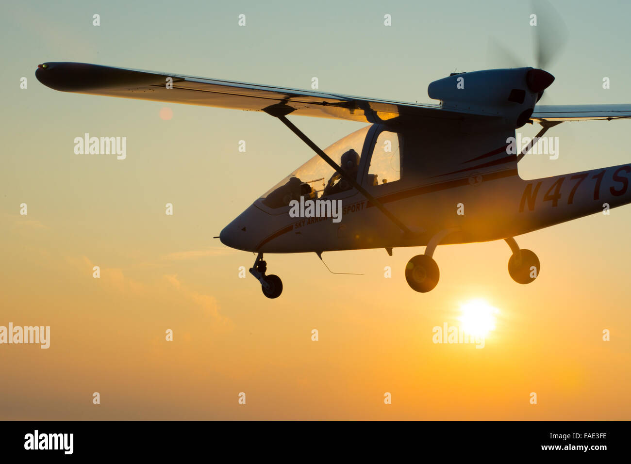 Plane flying at sunset in Maryland Stock Photo