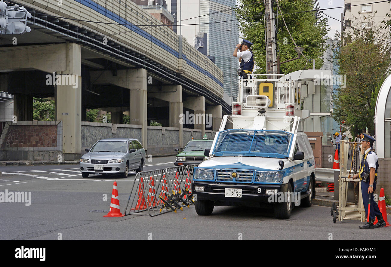 Japanese riot squad police keeping an eye out for trouble on a mobile viewing platform Stock Photo