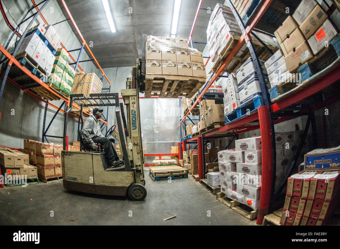 Workers managing the boxes inside of a wholesale produce market Stock Photo