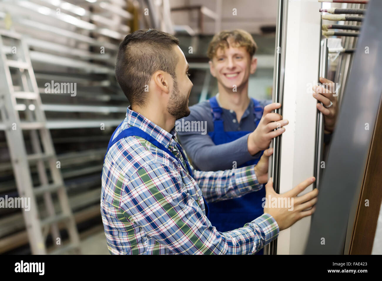 Pvc Salesman Two workmen choosing PVC at factory Stock Photo - Alamy