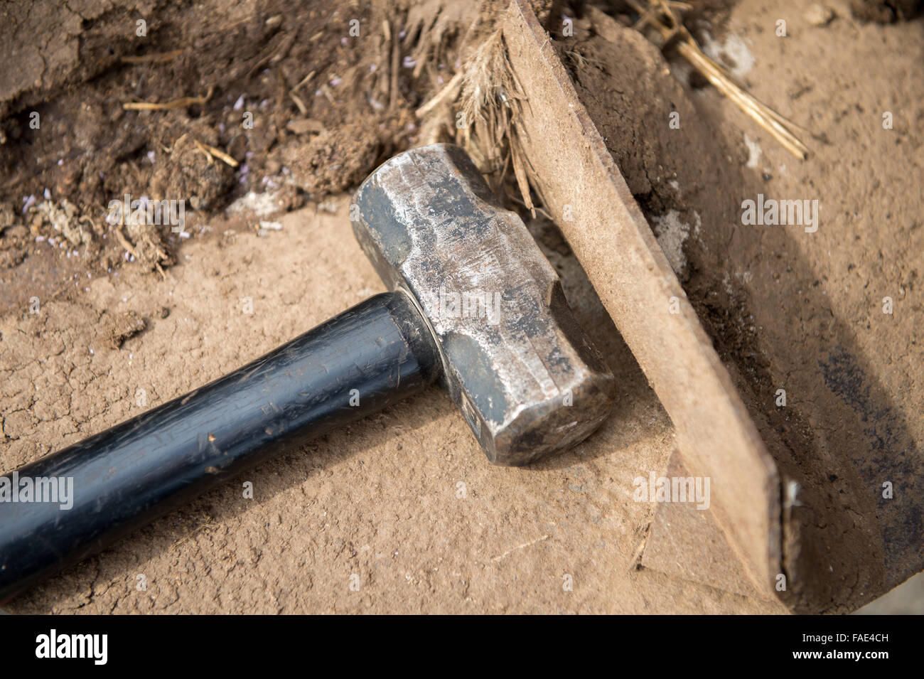 Sledge hammer laying on ground at a farm in Eden, Maryland Stock Photo
