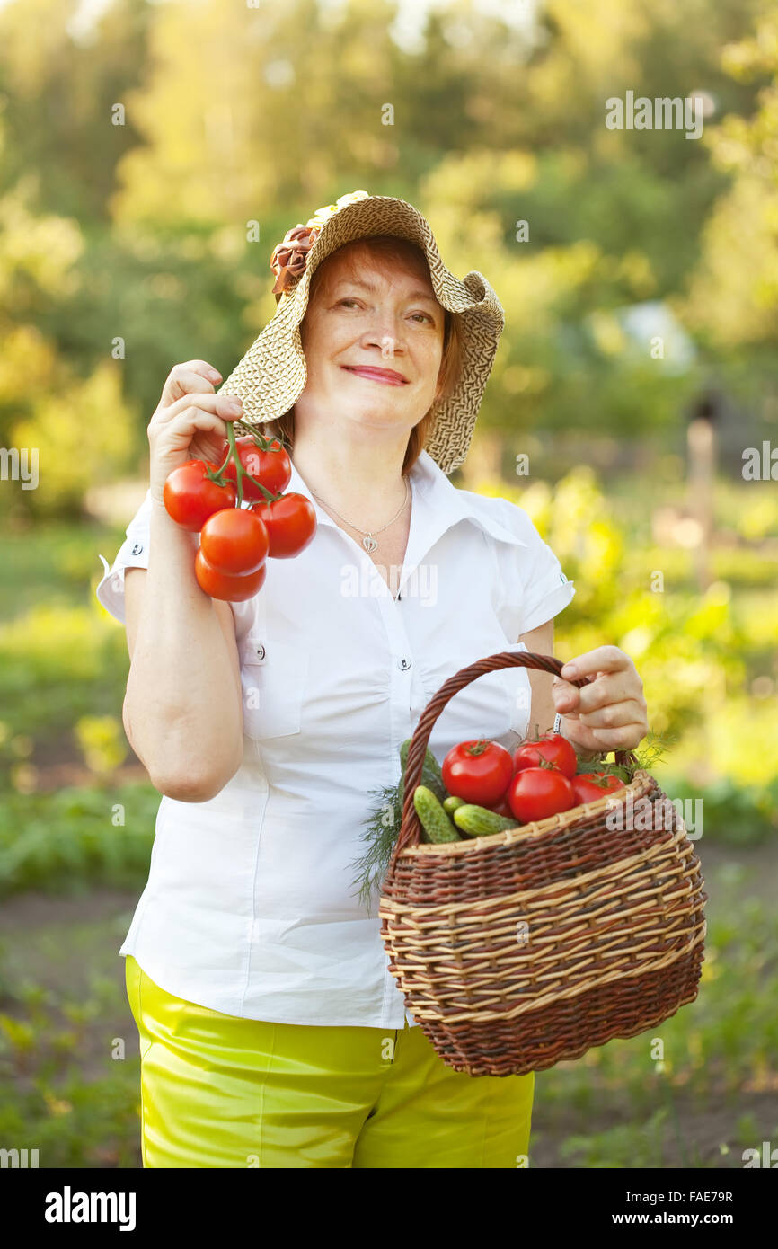 Happy mature woman with vegetables harvest Stock Photo - Alamy