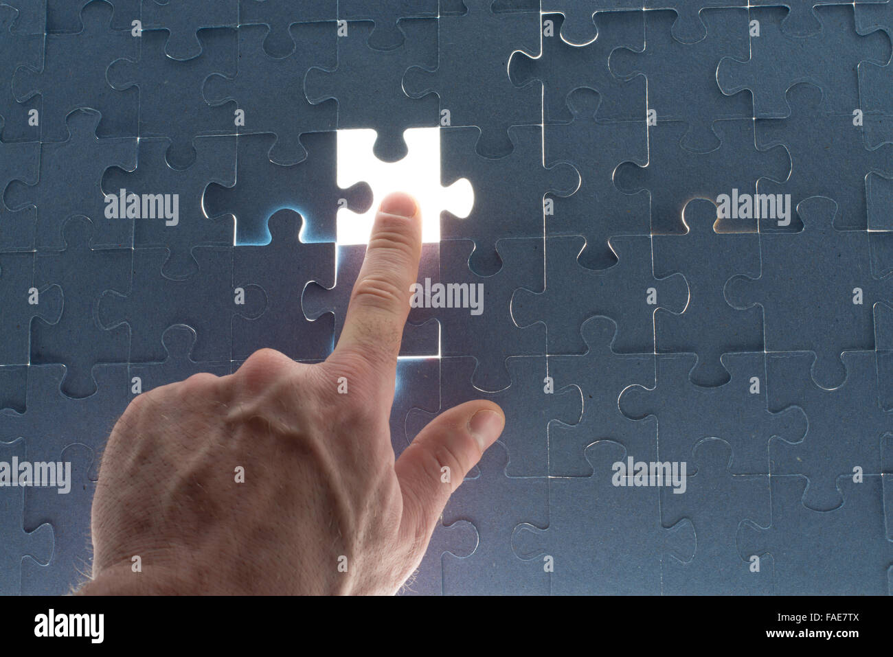 Missing jigsaw puzzle piece with light glow Stock Photo Alamy