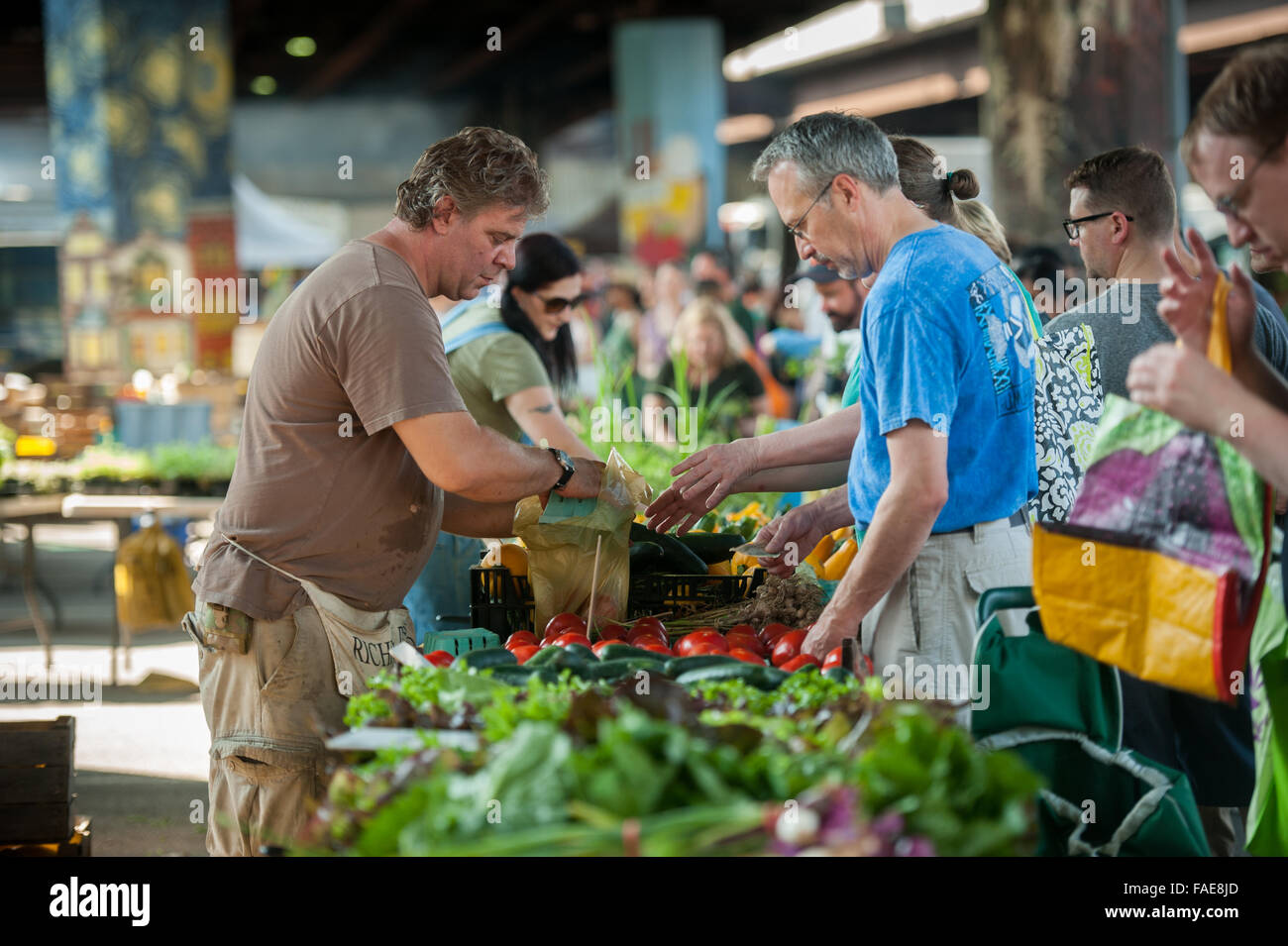 People buying produce at a local farmers market Stock Photo