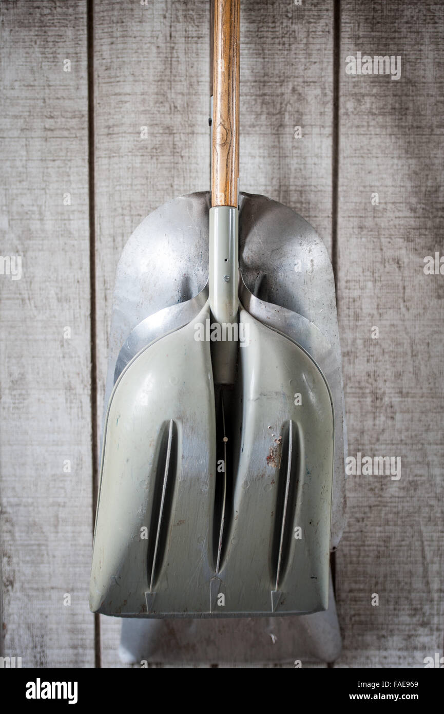 Shovels hanging on a wall in a wooden shed Stock Photo