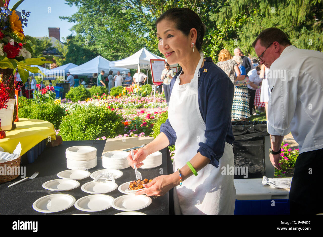 The first lady of Maryland, Yumi Hogan plating food at the Buy Local picnic. Stock Photo