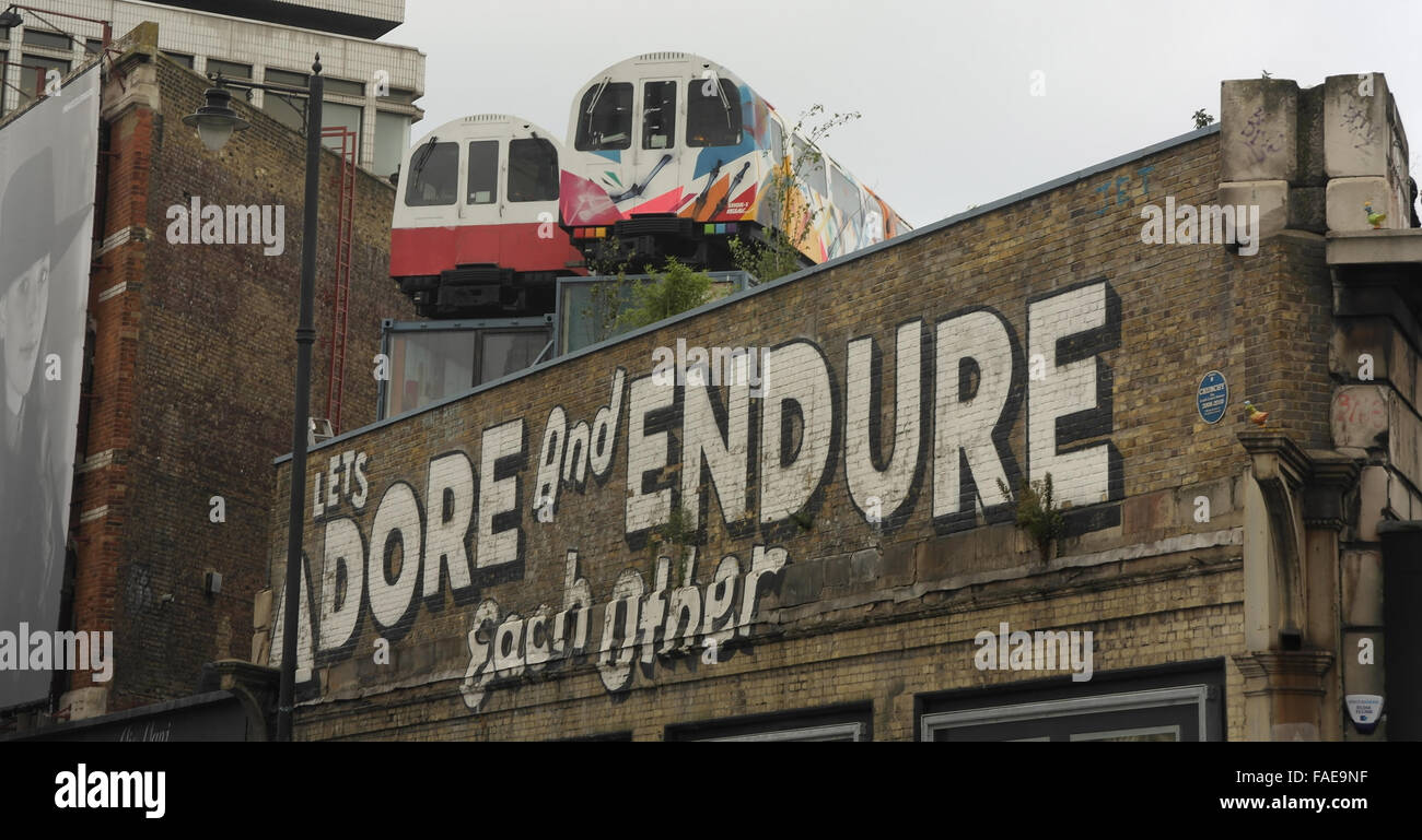 Grey sky view Jubilee Line train carriages on roof of Village ...