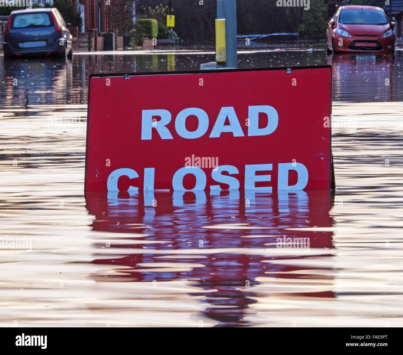 A picture of the scene at a flooded road junction showing a submerged 'Road Closed' sign Stock Photo