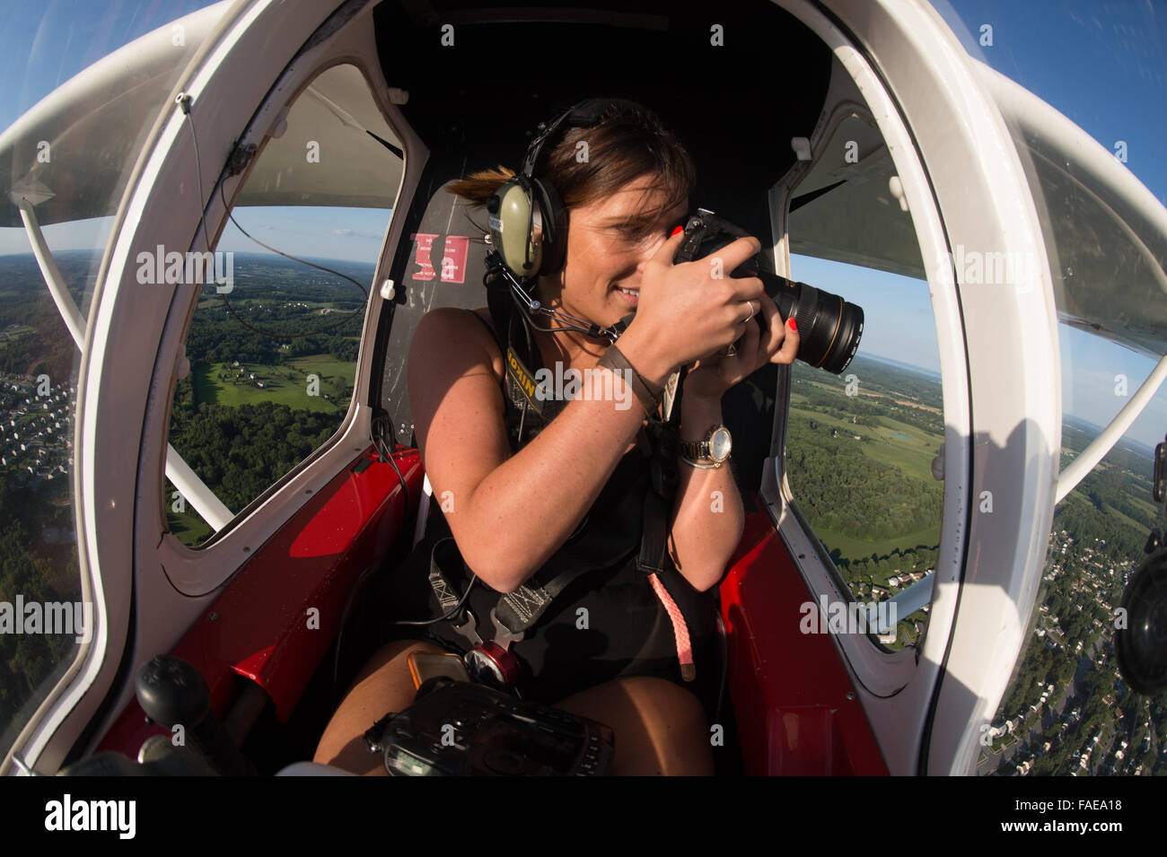 Photographer taking pictures from the side of a plane Stock Photo