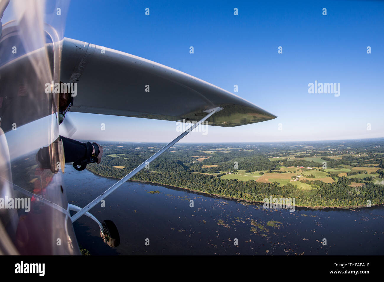 Photographer taking pictures from the side of a plane Stock Photo