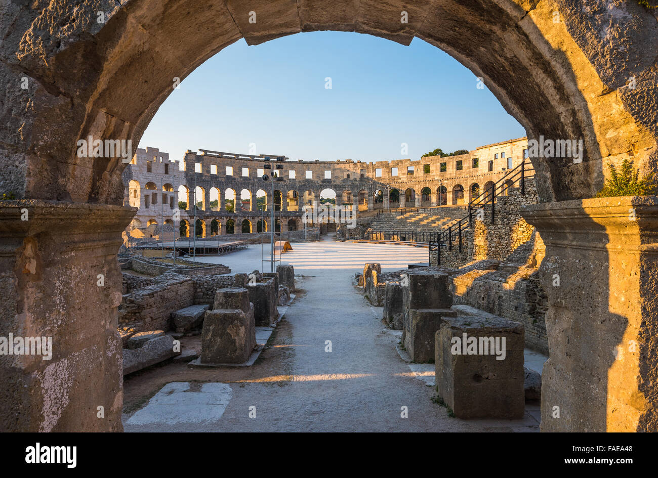 Architecture Details of the Roman Amphitheater Arena Seen through Big Round Arch in Sunny Summer Evening. Famous Travel Destinat Stock Photo
