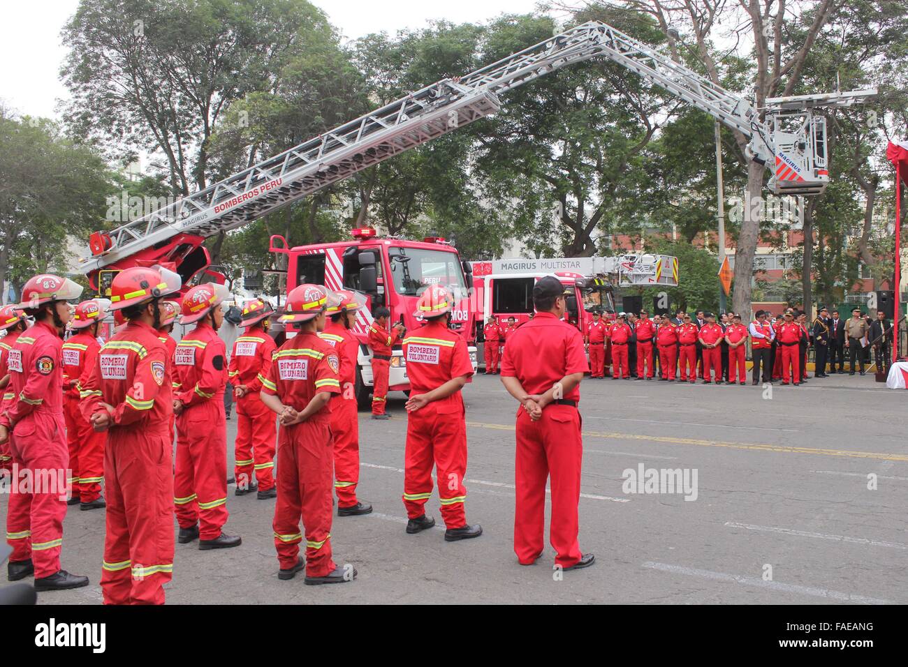 Lima, Peru. 28th Dec, 2015. Members of the General Corps of Volunteer Firefighters of Peru take part in a handing over ceremony of equipment, in Lima, capital of Peru, on Dec. 28, 2015. Peru's President Ollanta Humala took part in the handing over of three composite air units, 15 urban ambulances and 30 ambulances 4X4 that will be allocated to different regions of the country. Credit:  Luis Camacho/Xinhua/Alamy Live News Stock Photo