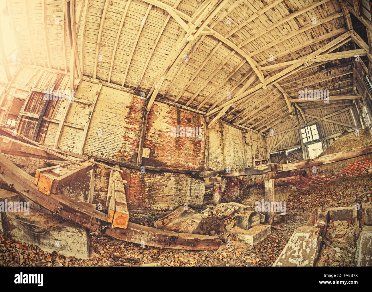 Retro toned fisheye photo of abandoned industrial building. Stock Photo