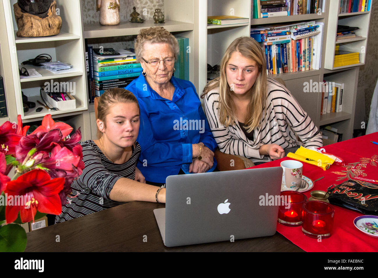 grandmother and grandchild looking at macbook computer Stock Photo