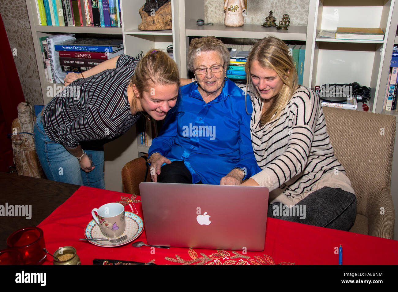 grandmother and grandchild looking at macbook computer Stock Photo