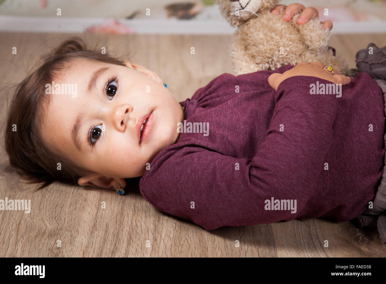 Portrait of 1 and a half gorgeous baby girl indoor. Stock Photo