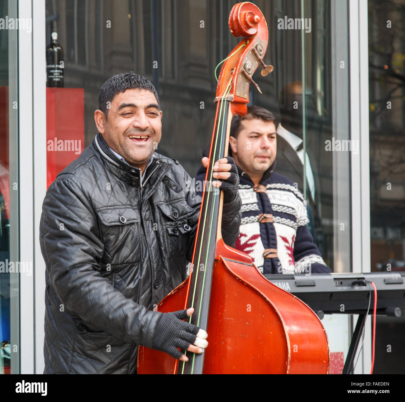 Busker playing a double bass in a Chilean street music band Stock Photo