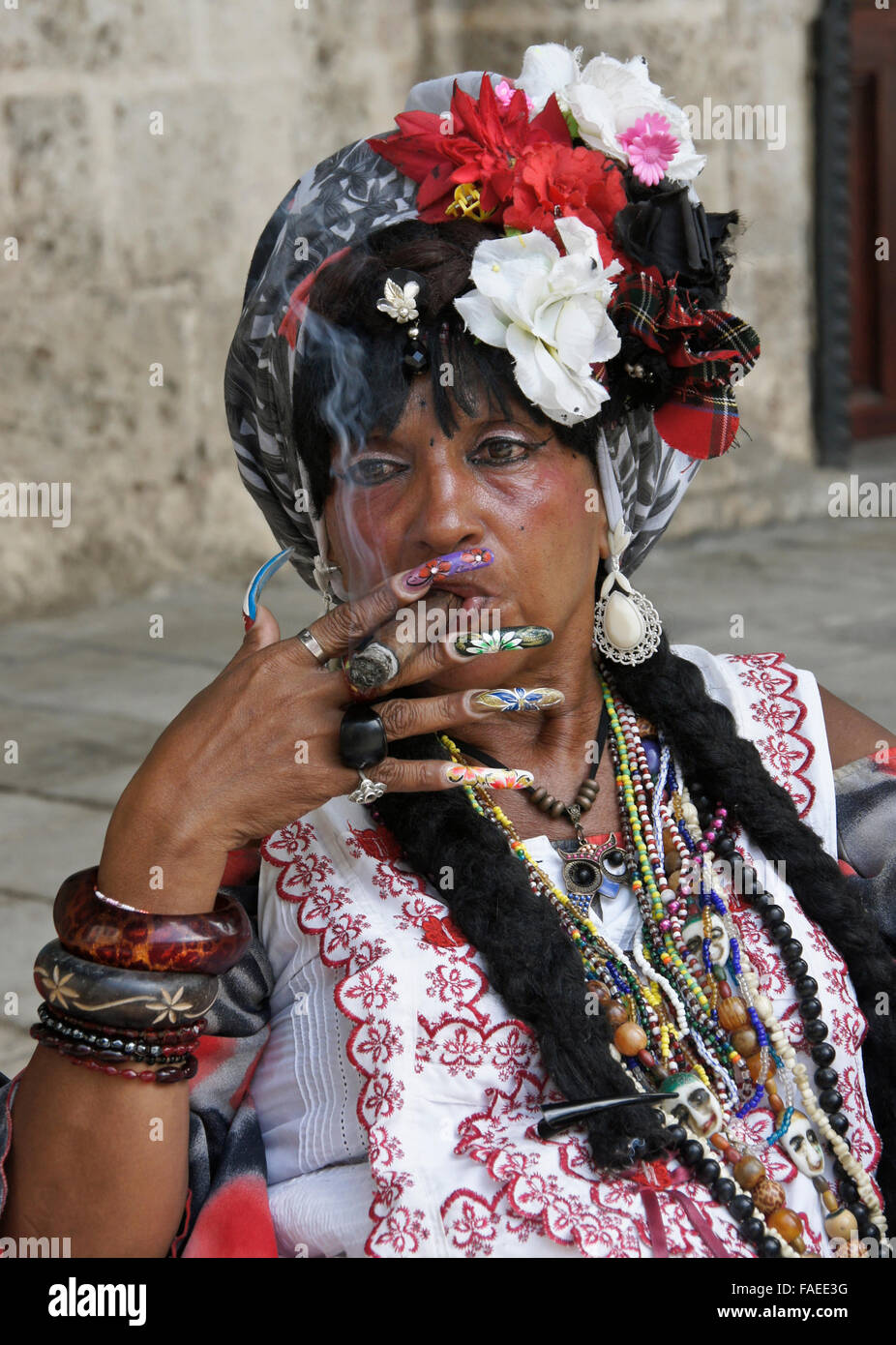 Colorful woman smoking cigar, Habana Vieja (Old Havana), Cuba Stock Photo