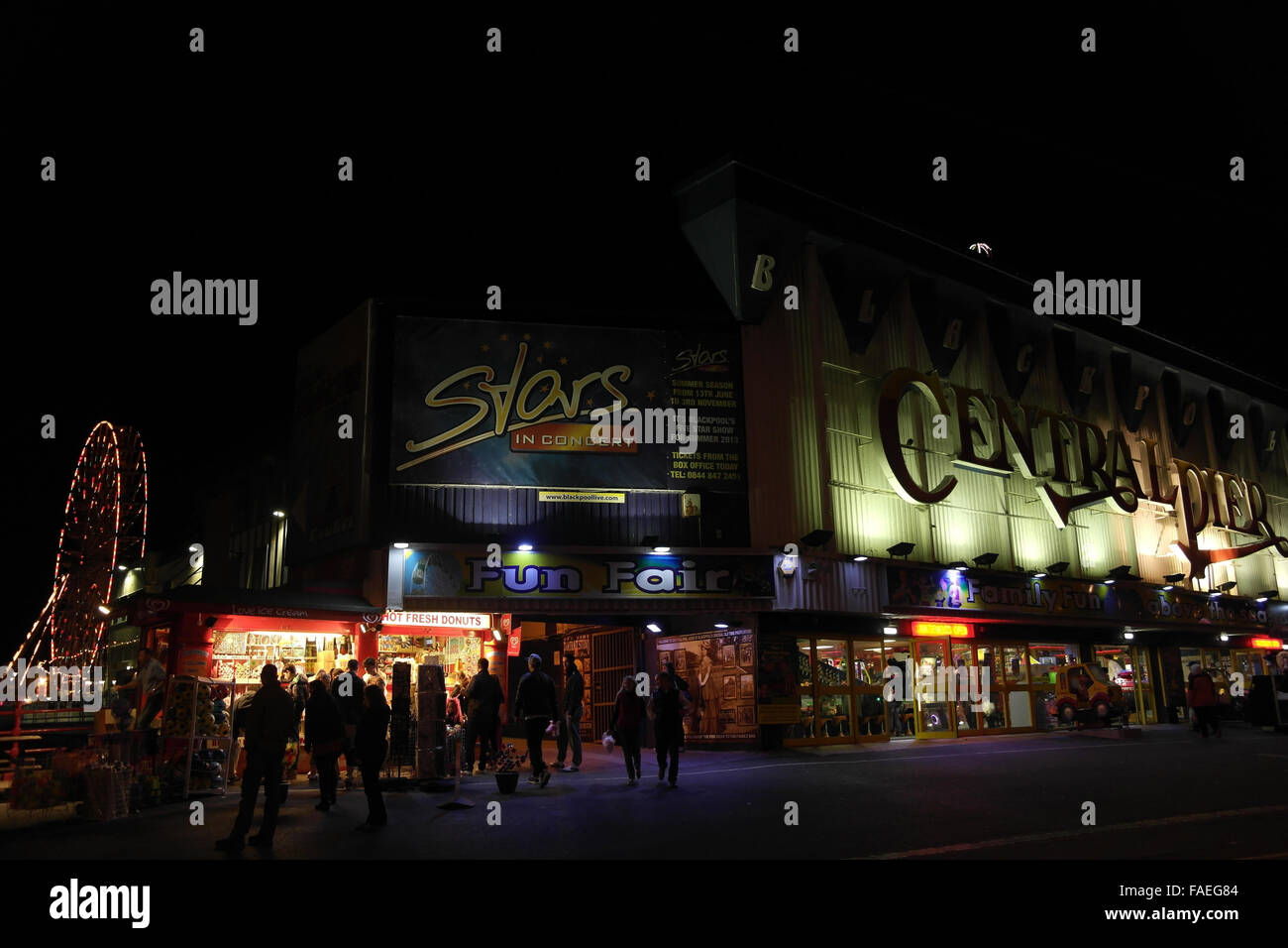 Night oblique view illuminated entrance Central Pier, with people