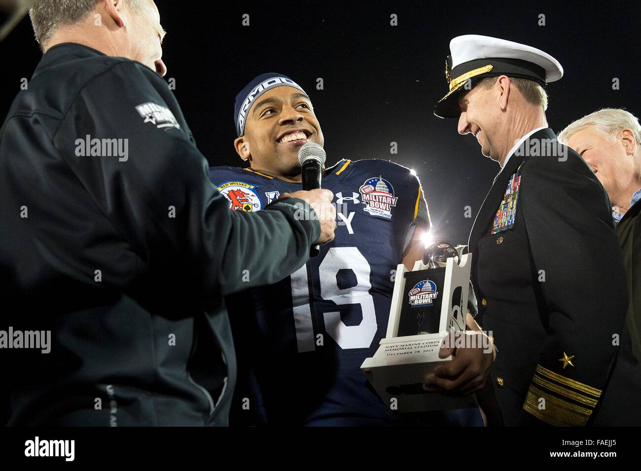 Annapolis, Maryland, USA. 28th Dec, 2015. U.S. Naval Academy quarterback Keenan Reynolds (19) accepts the Most Valuable Player trophy for Navy's 44-28 victory over Pittsburgh in the 2015 Military Bowl at Navy-Marine Corps Stadium December 28, 2015 in Annapolis, Maryland. Reynolds broke the NCAA Football Subdivision record for touchdowns with 88 and also set the career rushing yards with 4,559 yards. Stock Photo