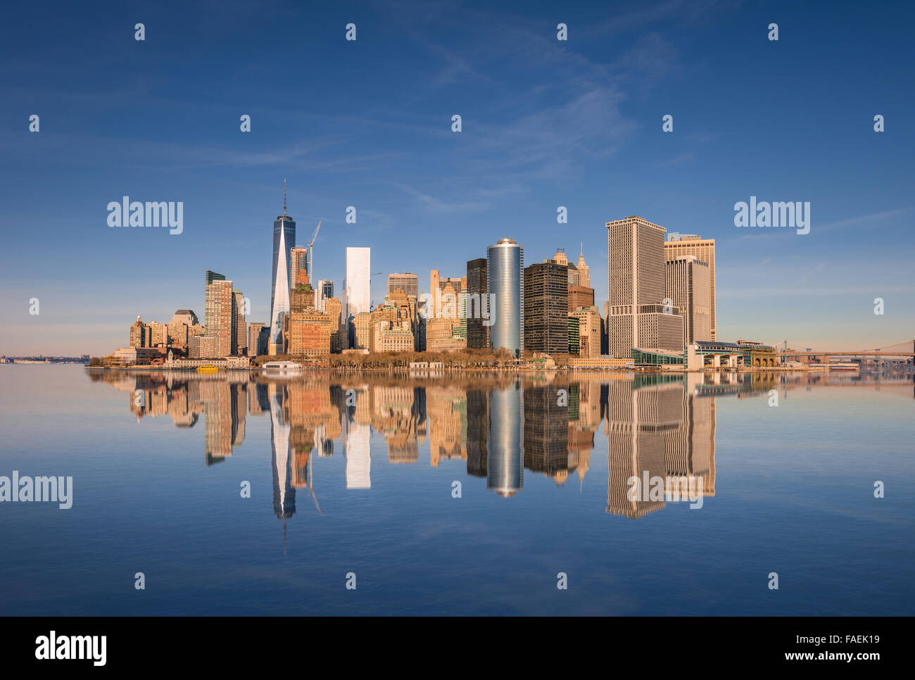 Lower Manhattan skyline panorama over East River with reflection. View ...