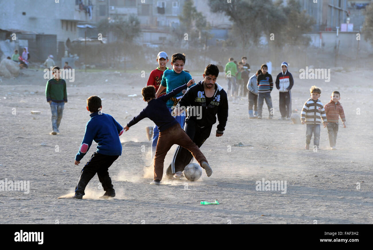 Damascus, Syria. 28th Dec, 2015. Syrian boys play football on a field