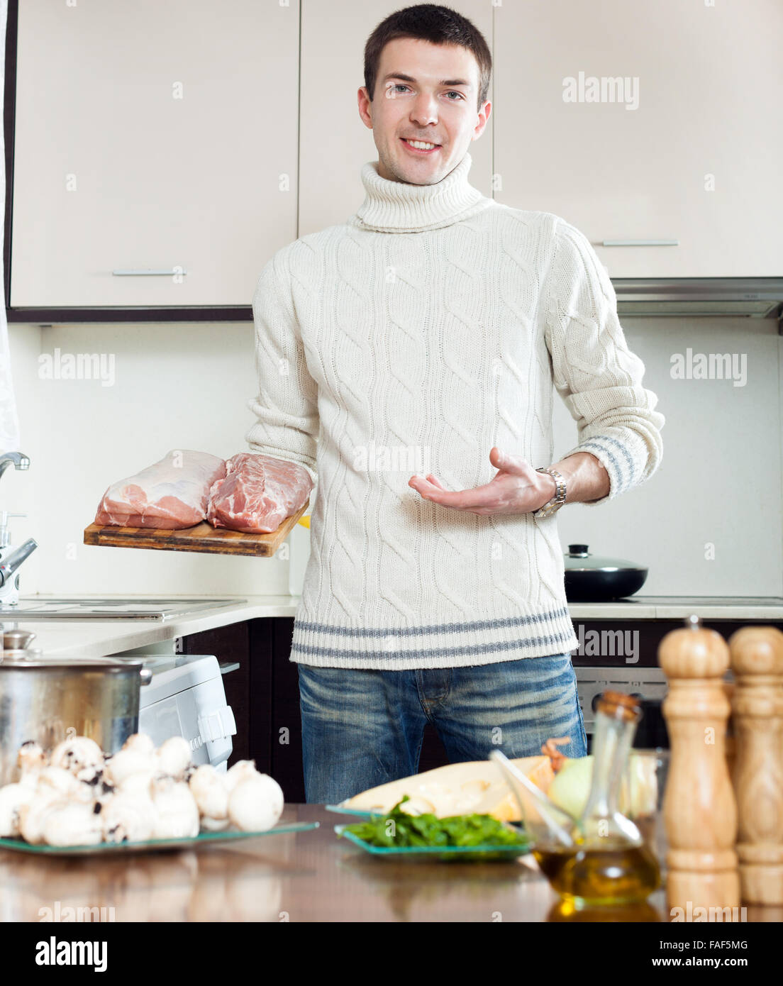 Steps of cooking frenchstyle meat in roasting pan. Hands cutting raw