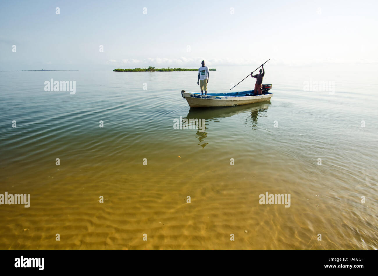 A small boat approaches Yele, in the Turtle Islands, Sierra Leone. Stock Photo