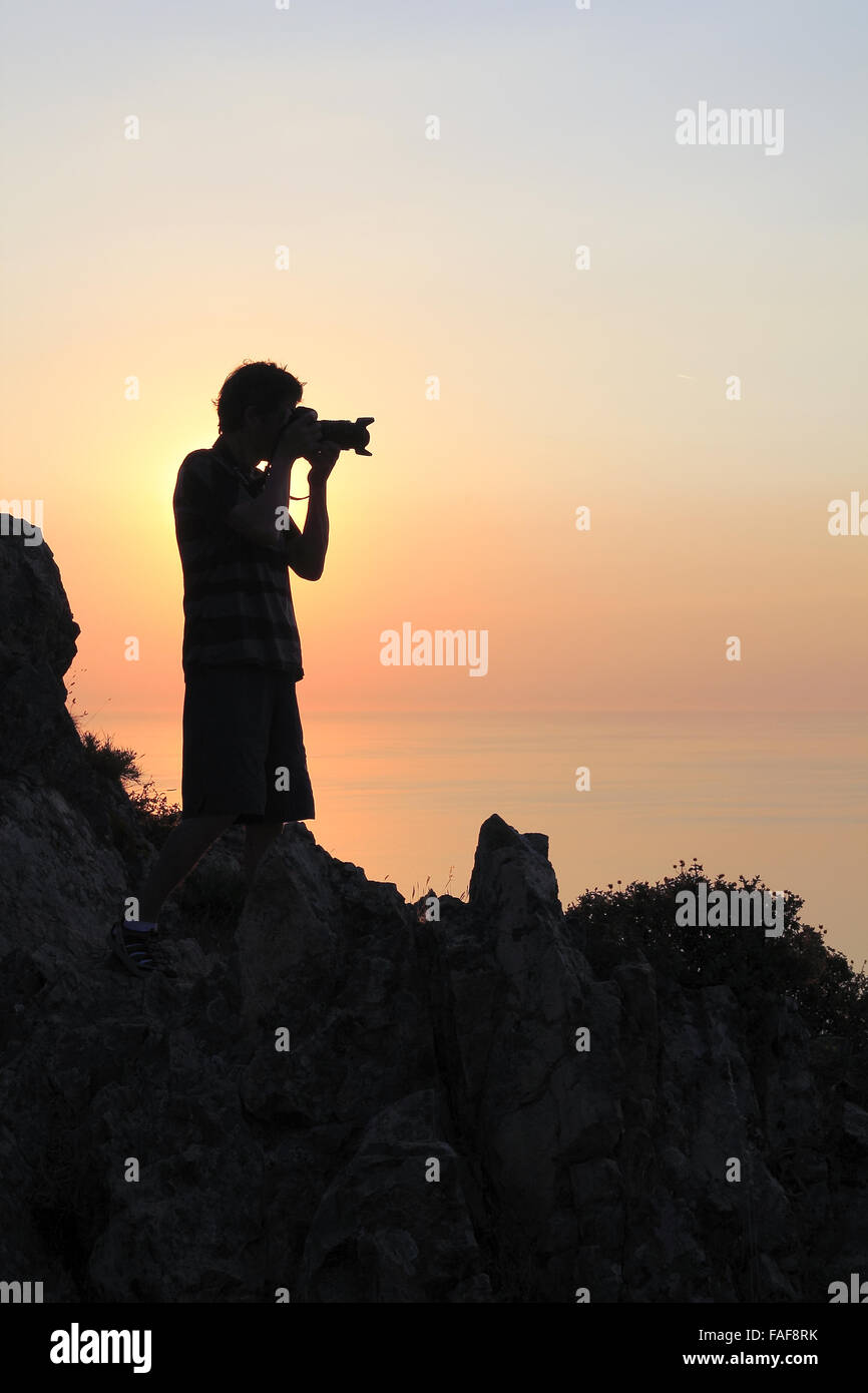 Portrait of a photographer in action at Piana Calanches, Corsica, France Stock Photo