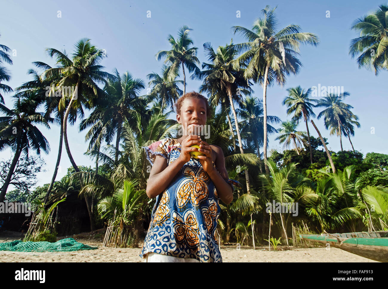 Girl eating a mango on Yele Island, the Turtle Islands, Sierra Leone. Stock Photo
