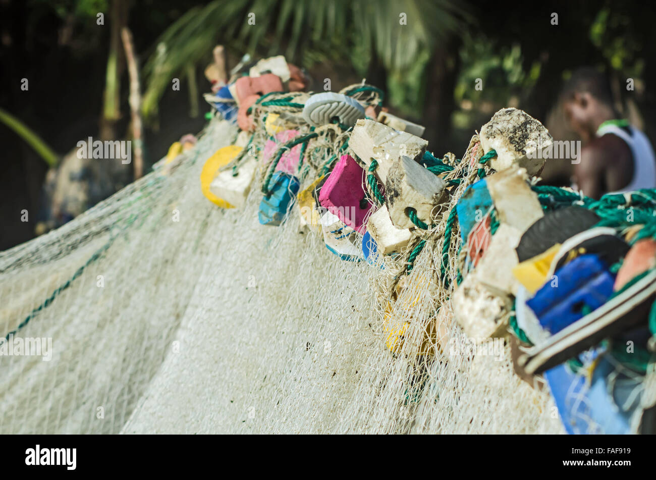 Recylced flip-flops on a fishing net in the Turtle Islands, Sierra Leone. Stock Photo