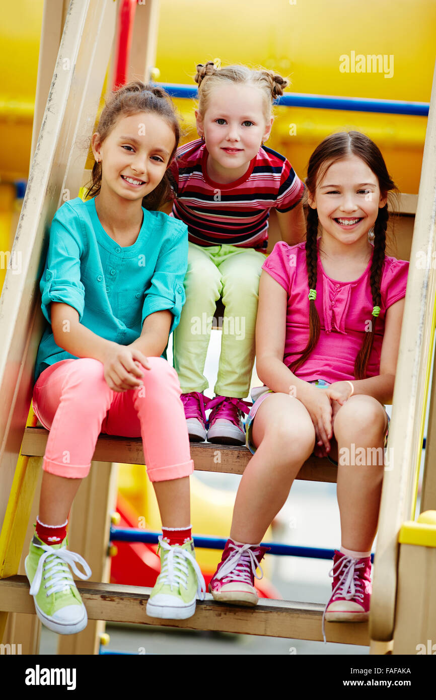 Little cute girls enjoys sunny day at the playground Stock Photo - Alamy