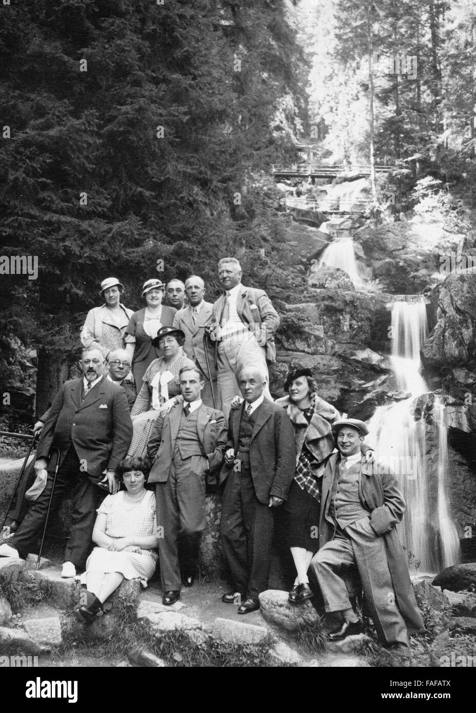 Reisegruppe der Heimatfreunde Köln posiert vor den Tribeger Wasserfällen im Schwarzwald, Deutschland 1930er Jahre. Tourist group in front of the Triberg Waterfalls at Black forest, Deutschland 1930s. Stock Photo