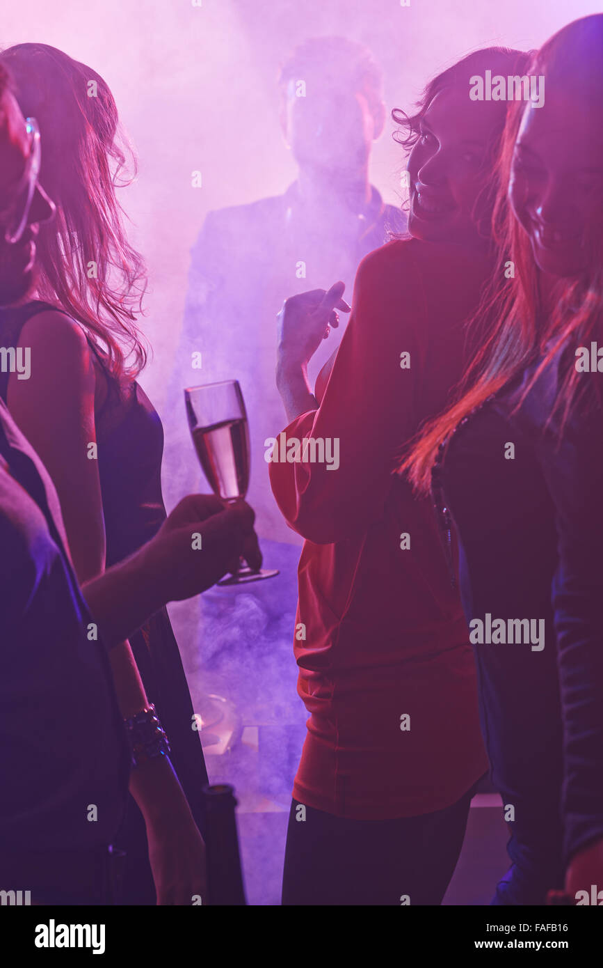 Girls with champagne flutes dancing at party Stock Photo