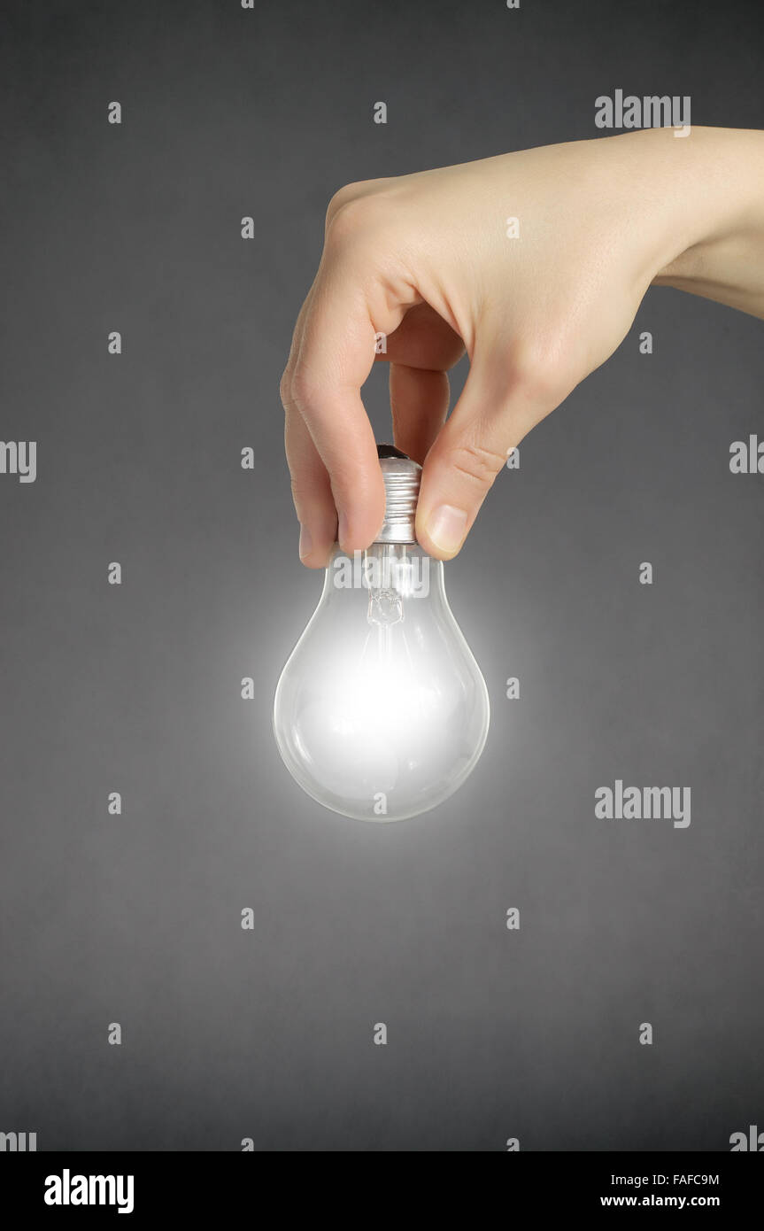 Hand holding a glowing light bulb Stock Photo - Alamy