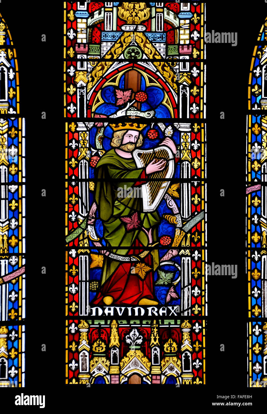 London, England, UK. All Saints Church, Margaret Street. Stained glass Window: King David playing the harp Stock Photo