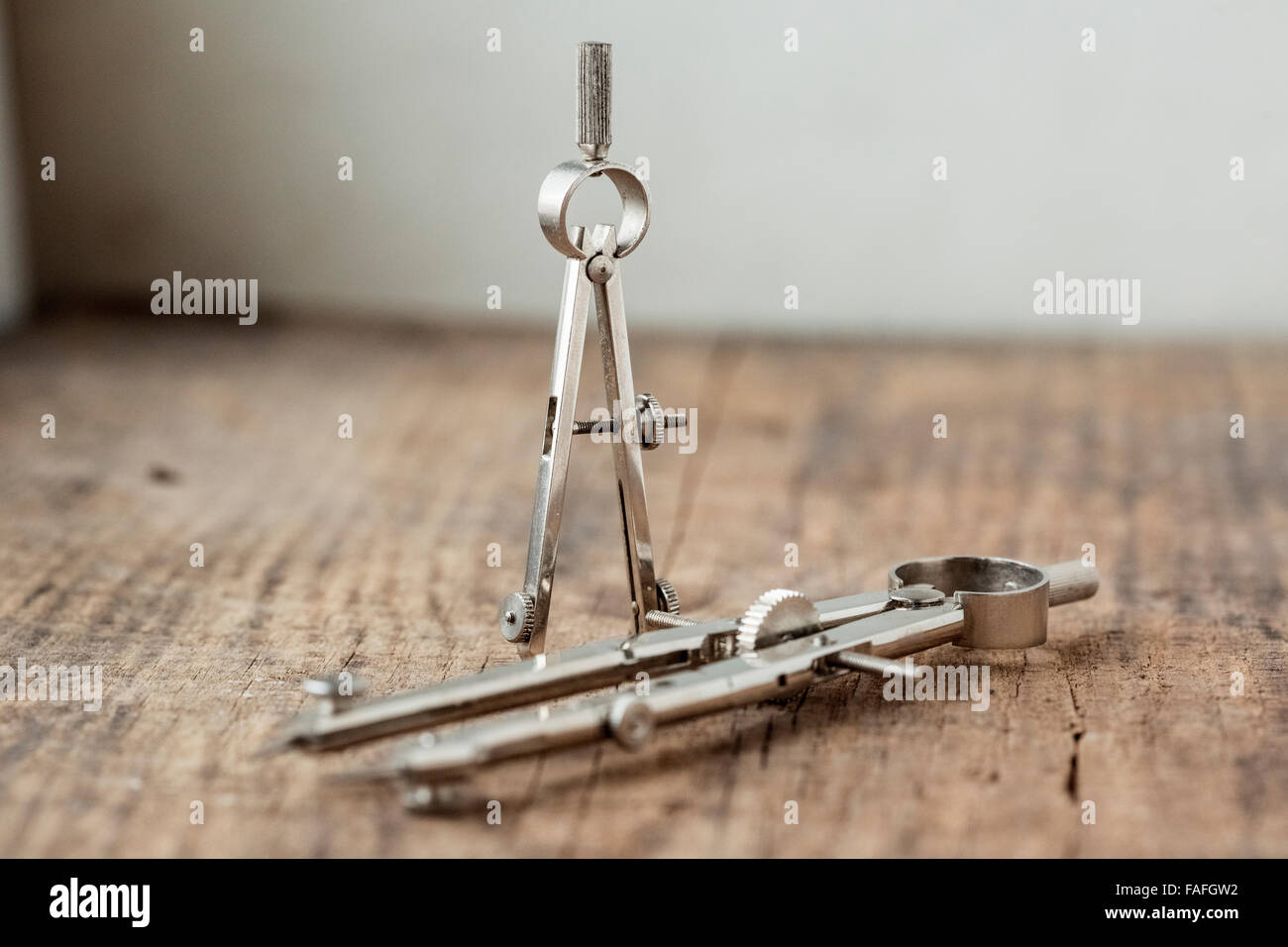 two compasses on the old wooden vintage table Stock Photo - Alamy