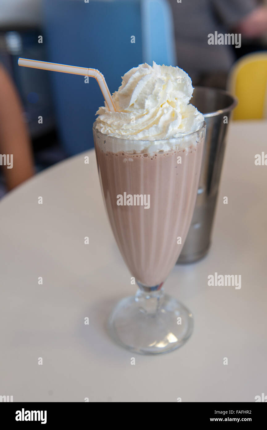 Large chocolate milk shake in glass with cream Stock Photo