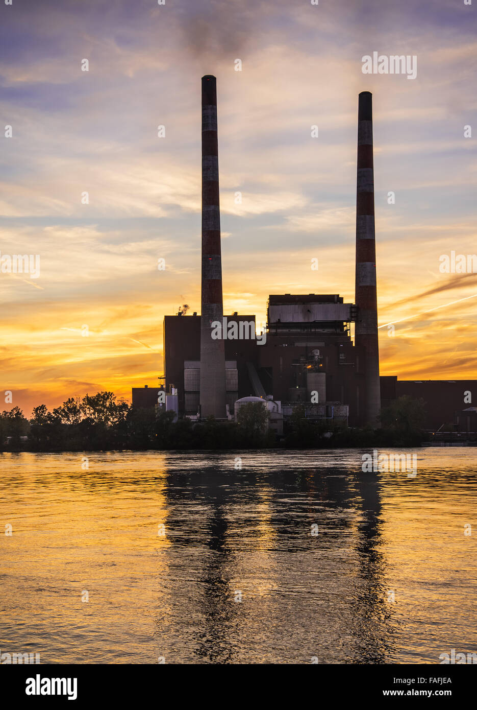 Tall Detroit Edison power plant smoke stacks at Sunset Stock Photo