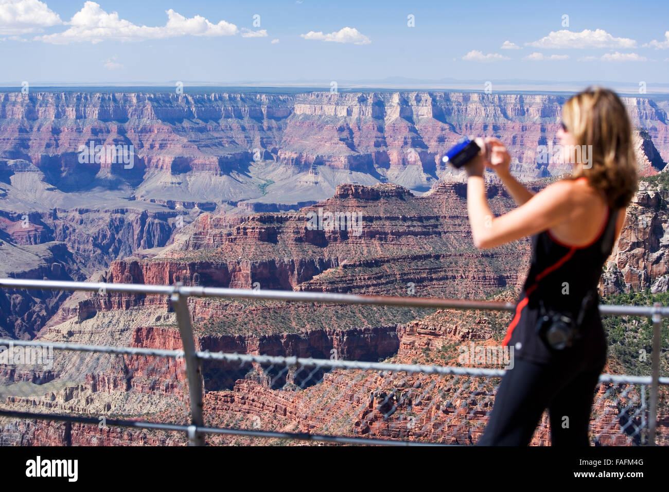 Woman taking photographs of Grand Canyon, Arizona, USA Stock Photo