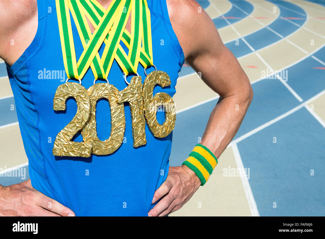 Gold medal 2016 athlete standing at blue and tan outdoor running track