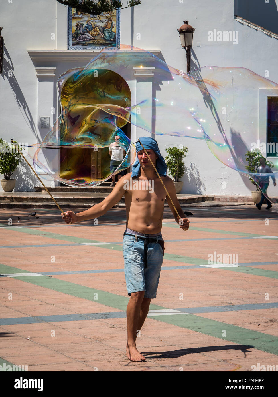 Man with Giant Bubble in the Square, Nerja, Costa del Sol, Spain Stock Photo