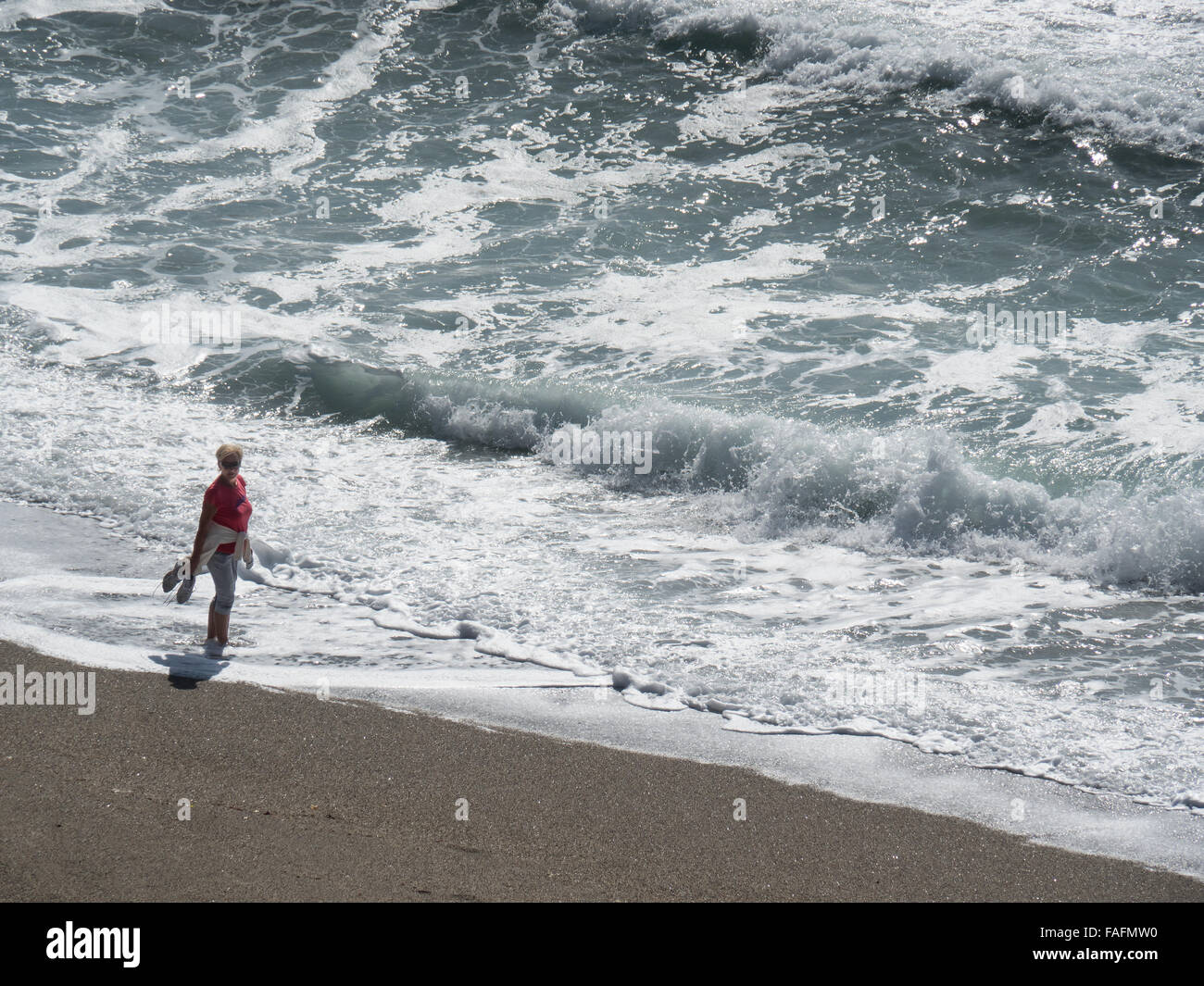 Woman Walking on Beach at Waters Edge, Nerja, Costa Del Sol, Spain, Stock Photo