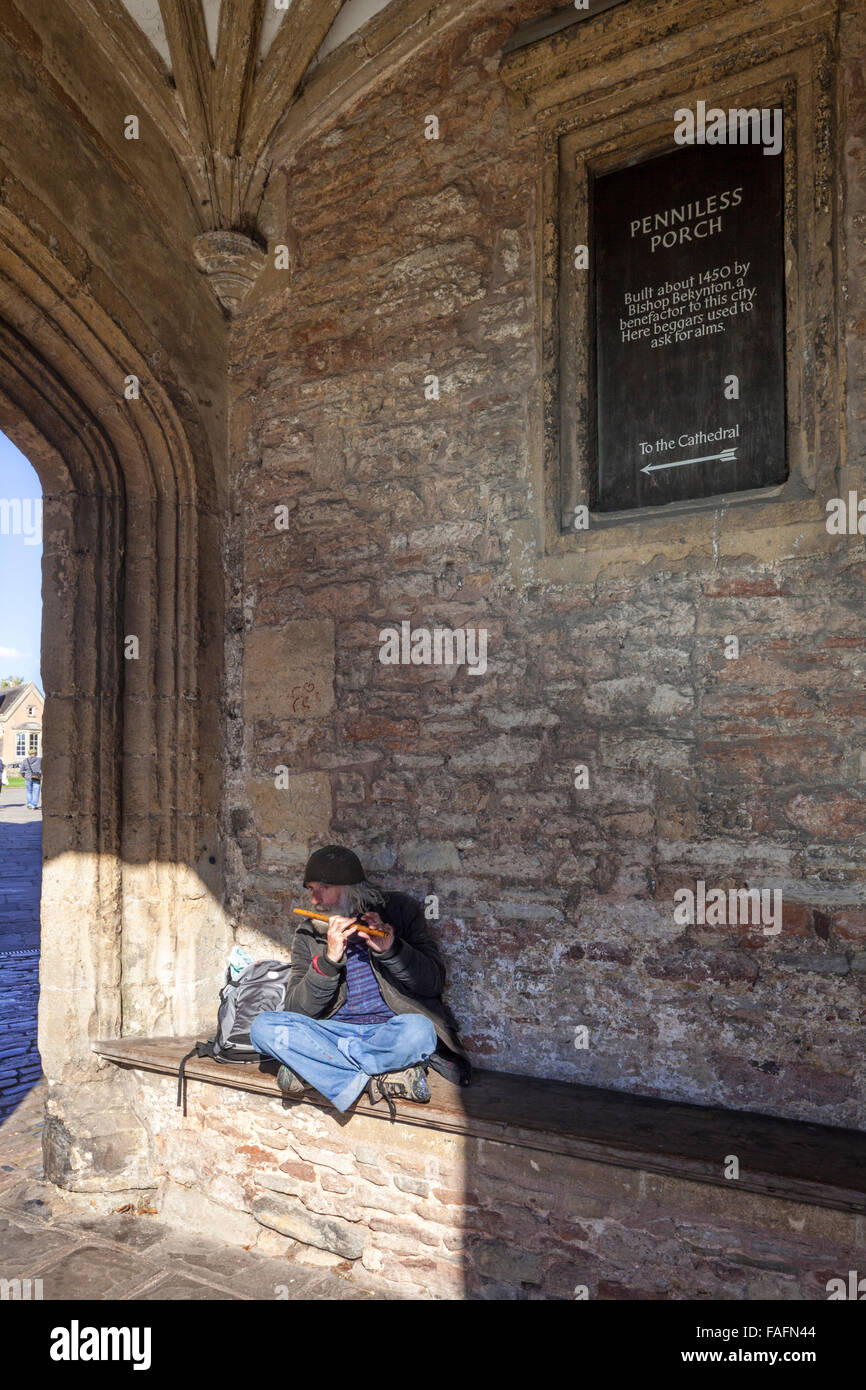 An itinerant musician playing the flute in Penniless Porch in the cathedral city of Wells, Somerset UK Stock Photo