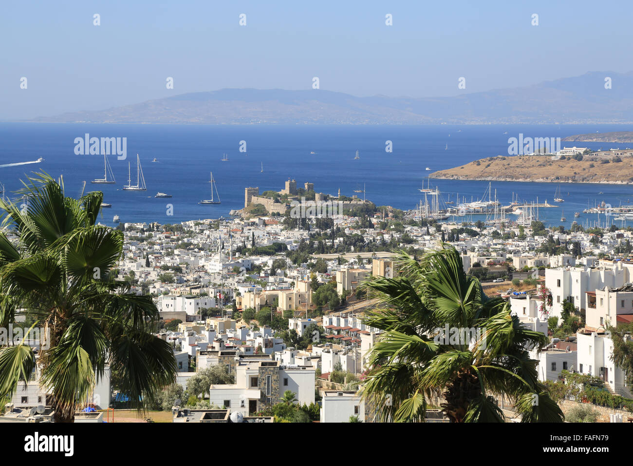 View across sea Bodrum Bay town, castle and harbour harbor port in Turkey from hillside in Summer sunshine Stock Photo