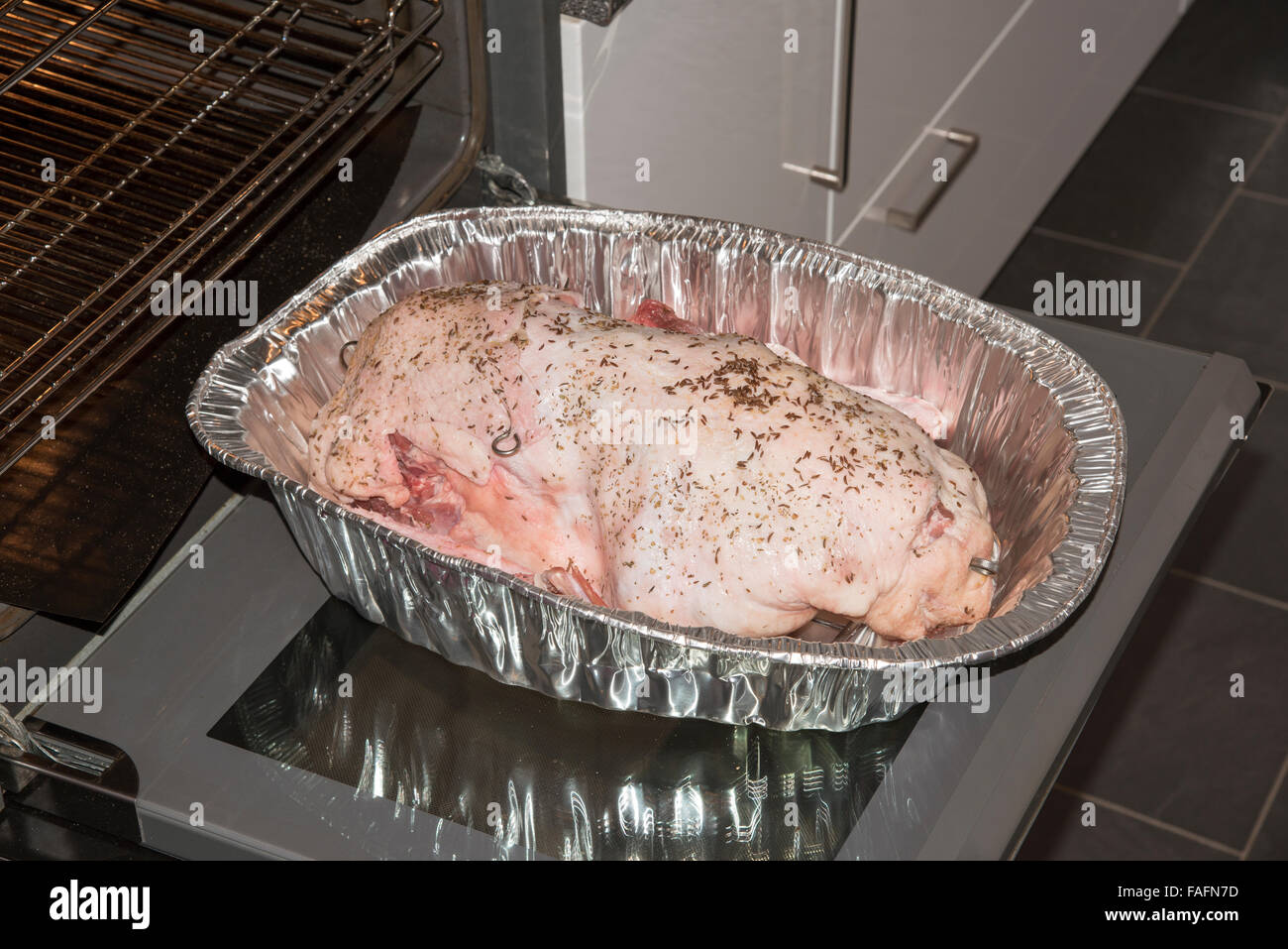 Cooking a goose in a silver foil tray for Christmas lunch The prepared