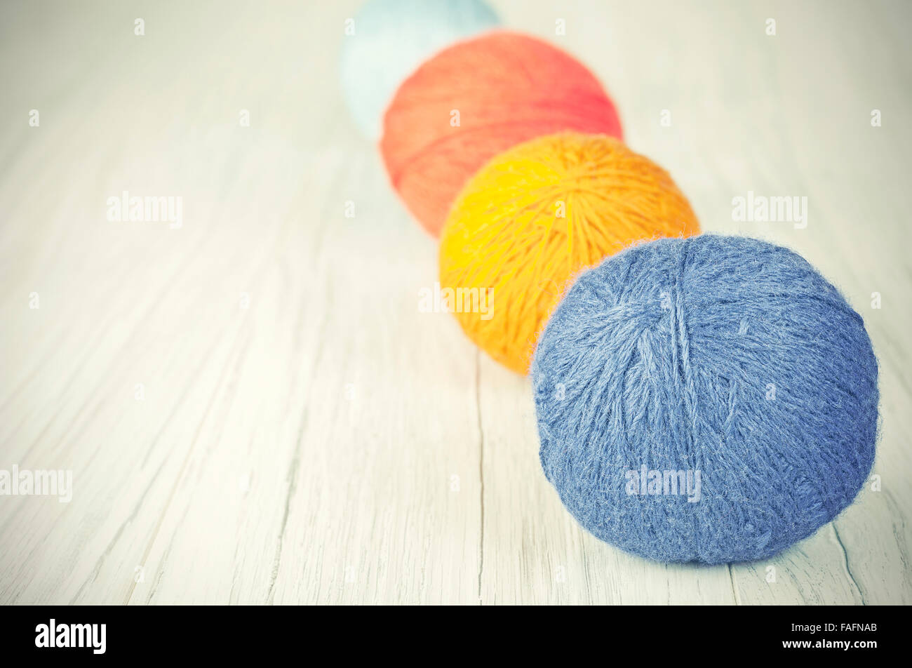 Retro toned yarn balls background, space for text. Stock Photo