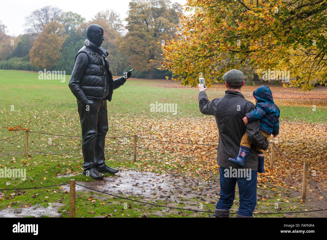 Thomas Price's 'Network' being photographed by mobile phone on a wet day at the Yorkshire Sculpture Park, Wakefield, West Yorkshire UK Stock Photo